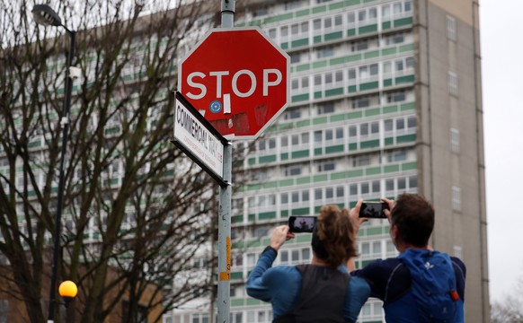 epa11042901 Local Londoners photograph a replaced stop sign on Commercial Way in Peckham, South London, UK, December 24, 2023. A stop sign has been replaced at the site of a stolen Banksy stop sign...
