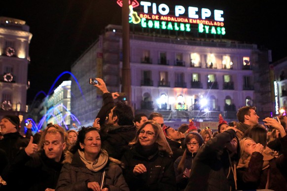 epa06410996 People gather at Puerta del Sol during the &#039;Preuvas&#039;, a test for New Year&#039;s Eve celebrations, in Madrid, Spain, 30 December 2017. Twelve strokes will sound at midnight to im ...