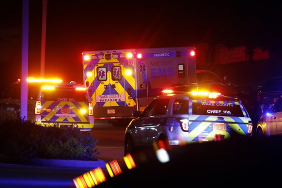 An ambulance believed to be carrying a shooting suspect arrives at Wake Medical Center Emergeny Room in Raleigh, N.C., Thursday, Oct. 13, 2022 surrounded by police. (AP Photo/Karl DeBlaker)