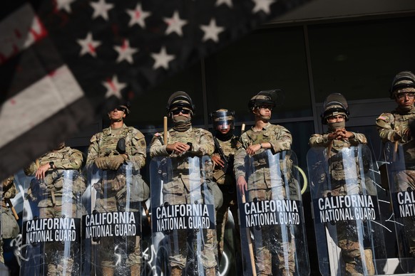 National Guard soldiers are posted near an entrance to the Federal Building in Los Angeles during a demonstration in response to a series of United States Immigration and Customs Enforcement (ICE) rai ...