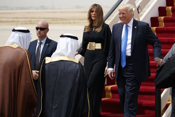 U.S. President Donald Trump, accompanied by first lady Melania Trump, smiles at Saudi King Salman, left, upon his arrival at a welcome ceremony at the Royal Terminal of King Khalid International Airpo ...