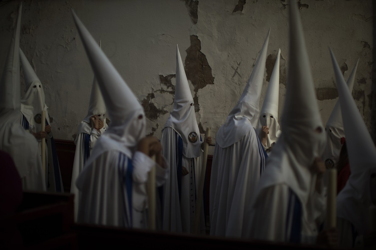 Hooded penitents from "La Sed" brotherhood take part in a procession in Jerez de la Frontera, Cadiz province in Andalucia, southern Spain, Monday, April 15, 2019. Hundreds of processions tak ...