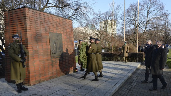 Representatives the presidents of Germany and Poland, Stephan Steinlein ,second left, and Krzysztof Szczerski,right, take part in a wreath-laying ceremony at a memorial to former German Chancellor Wil ...