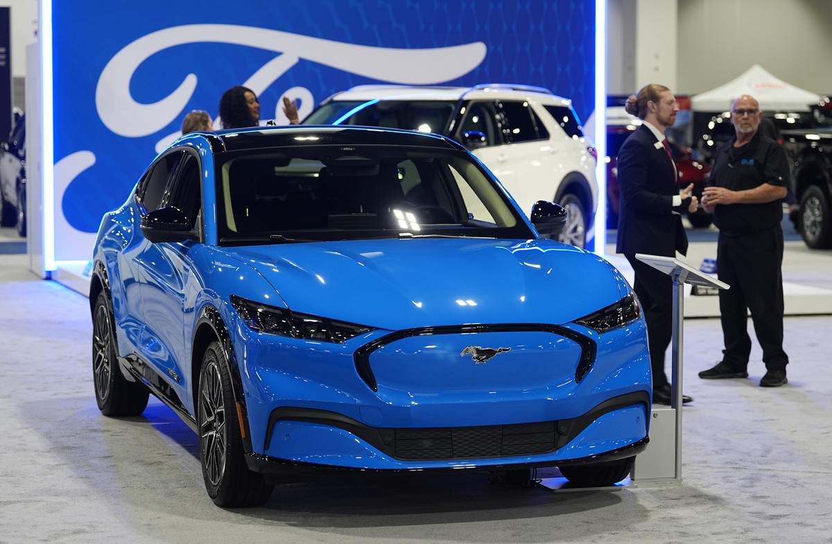 A 2024 Mach E electric sports-utility vehicle sits on display in the Ford exhibit at the Denver Auto Show Thursday, April 4, 2024, in Denver. (AP Photo/David Zalubowski)