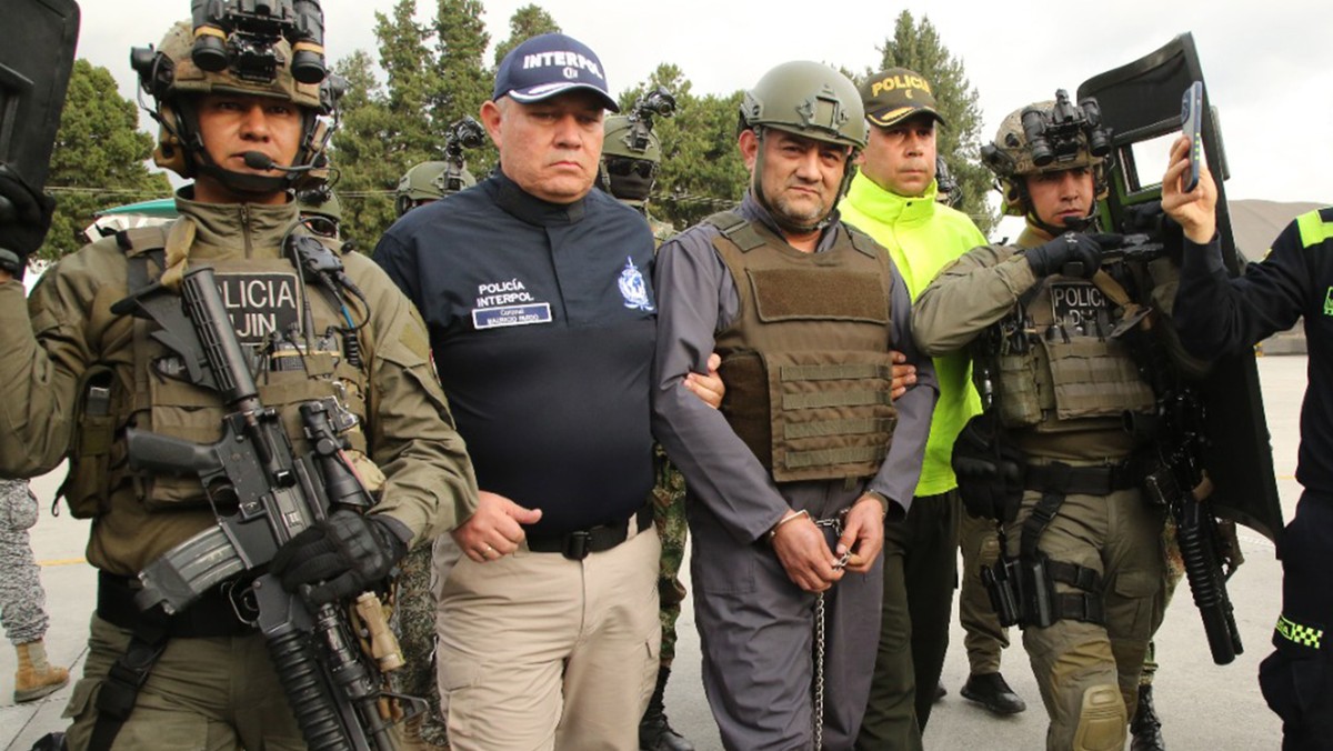epa09927390 A handout photo made available by the Colombian Presidency shows the head of the Clan del Golfo, Dairo Antonio Usuga (C-R), alias 'Otoniel' during his extradition to the United S ...