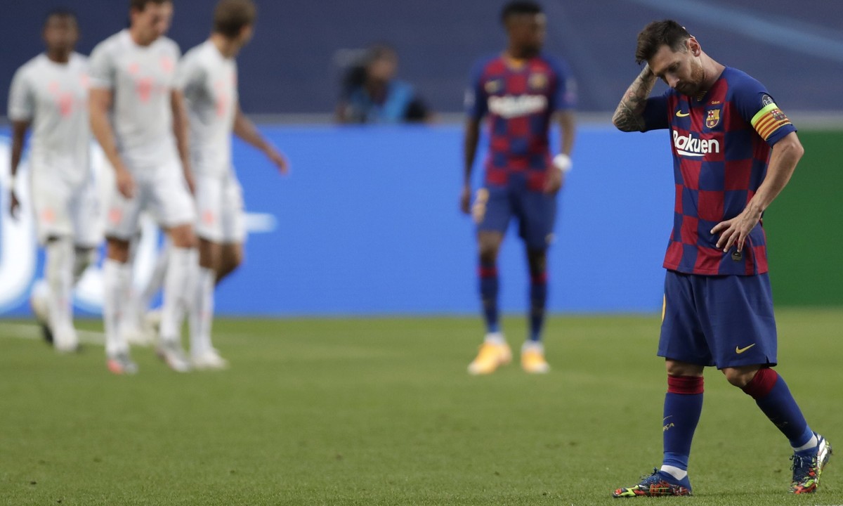 Barcelona's Lionel Messi holds his head during the Champions League quarterfinal match between FC Barcelona and Bayern Munich at the Luz stadium in Lisbon, Portugal, Friday, Aug. 14, 2020. Gerard ...