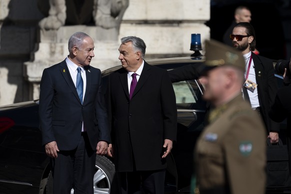 Israeli Prime Minister Benjamin Netanyahu, left, and Hungarian Prime Minister Viktor Orban, center, participate in a welcoming ceremony with a guard of honor at Buda Castle in Budapest, Hungary, April ...