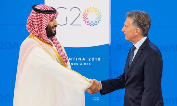 epa07199627 A handout photo made available by the Saudi Royal Court shows Saudi Crown Prince Mohammad Bin Salman (L) shaking hands with Argentina&#039;s President Mauricio Macri, during the G20 Summit ...