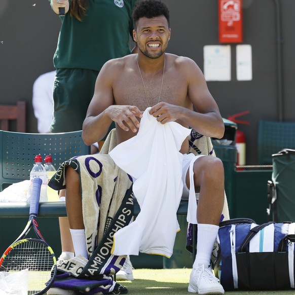 JoâWilfried Tsonga of France changes his shirt during the Men&#039;s Singles Match against Italy&#039;s Simone Bolelli on day three at the Wimbledon Tennis Championships in London Wednesday, July 5, ...