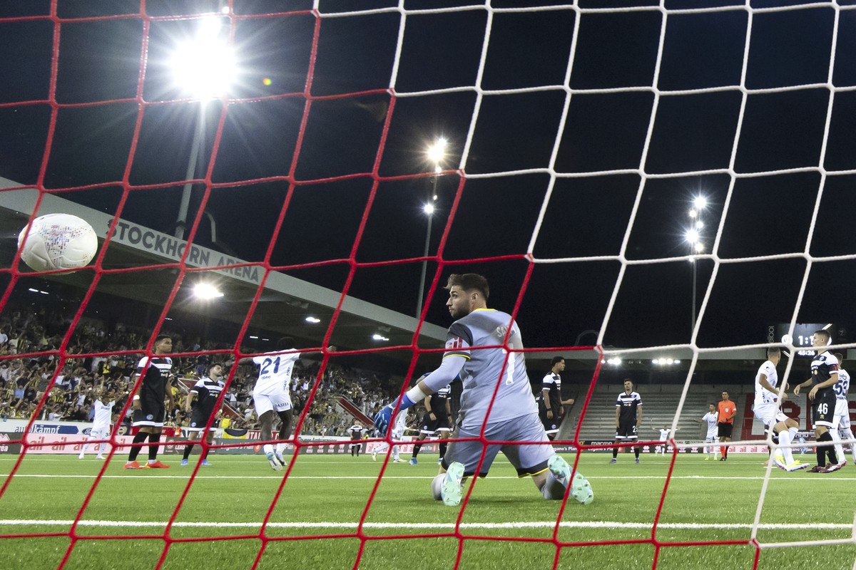 Lugano's goalkeeper Amir Saipi looks at the ball after Fenerbahce's Edin Dzeko scored his side's second goal during a UEFA Champions League qualifying second round first leg soccer matc ...