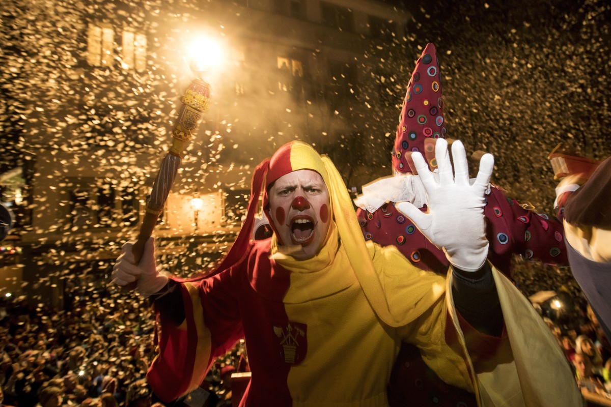 Costumed revelers attend the 'Urknall' (Big Bang), which initiates at 5 o'clock in the morning the carnival (Fasnacht) of Lucerne, Switzerland, Thursday, February 28, 2019. The carnival ...