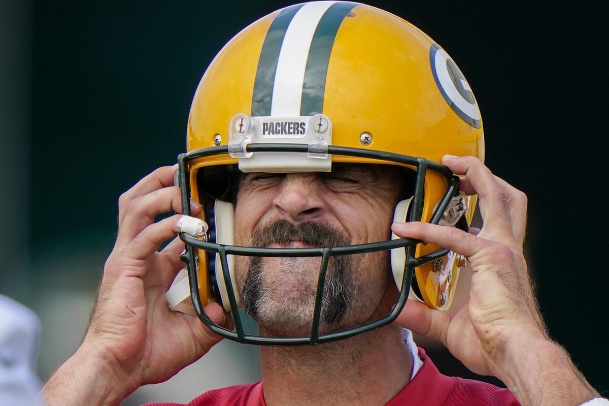 Green Bay Packers' Aaron Rodgers puts on his helmet during NFL football training camp Saturday, Aug. 15, 2020, in Green Bay, Wis. (AP Photo/Morry Gash)