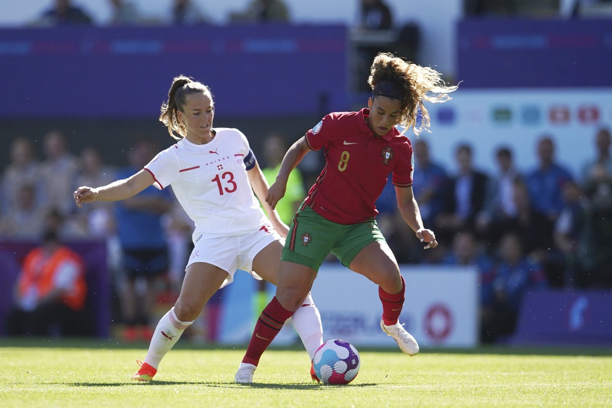Switzerland's Lia Waelti, left, challenges for the ball with Portugal's Andreia Norton during the Women Euro 2022 soccer match between Portugal and Switzerland at Leigh Sports Village in Wig ...