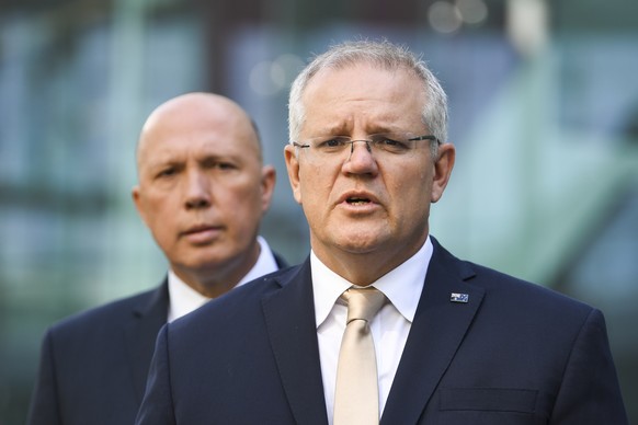 epa08048147 Australian Prime Minister Scott Morrison (R) speaks to the media during an announcement to increase counter-terrorism measures at Canberra Airport, in Canberra, Australia, 06 December 2019 ...