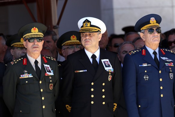 Turkish army&#039;s top commanders, from left, Land Forces Commander Gen. Hulusi Akar, Navy Commander Adm. Bulent Bostanoglu and Air Forces Commander Akin Ozturk stand during a state funeral for Kenan ...