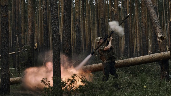 A Ukrainian soldier fires an RPG toward Russian positions at the frontline near Kremenna in the Luhansk region, Ukraine, Tuesday, May 9, 2023. (AP Photo/LIBKOS)