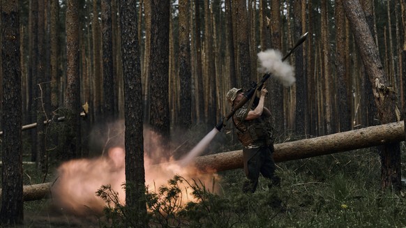 A Ukrainian soldier fires an RPG at Russian frontline positions near Kremenna in the Luhansk region, Ukraine, May 9, 2023. (AP Photo/LIBKOS)
