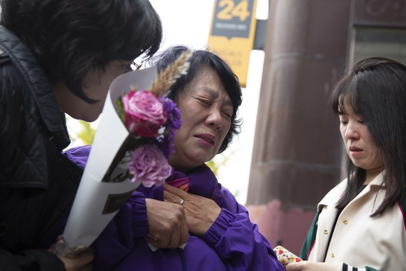 epa10939893 Lee Hyo-suk (C), mother of late Jung Ju-hee, cries as members of the &#039;10.29 Itaewon Disaster Bereaved Families&#039; group visit a memorial at the site of the Itaewon tragedy in Seoul ...