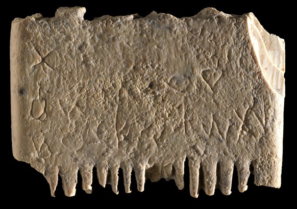 This undated image released by the Israel Antiquities Authority on Wednesday, Nov. 9, 2022, shows an ivory comb with an entire sentence in the Canaanite language, a 3,700-year-old inscription encourag ...