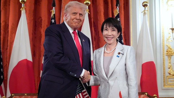 President Donald Trump, left, and Japan's Prime Minister Sanae Takaichi shake hands during a signing ceremony at Akasaka Palace in Tokyo, Japan, Tuesday, Oct. 28, 2025. (AP Photo/Mark Schiefelbei ...