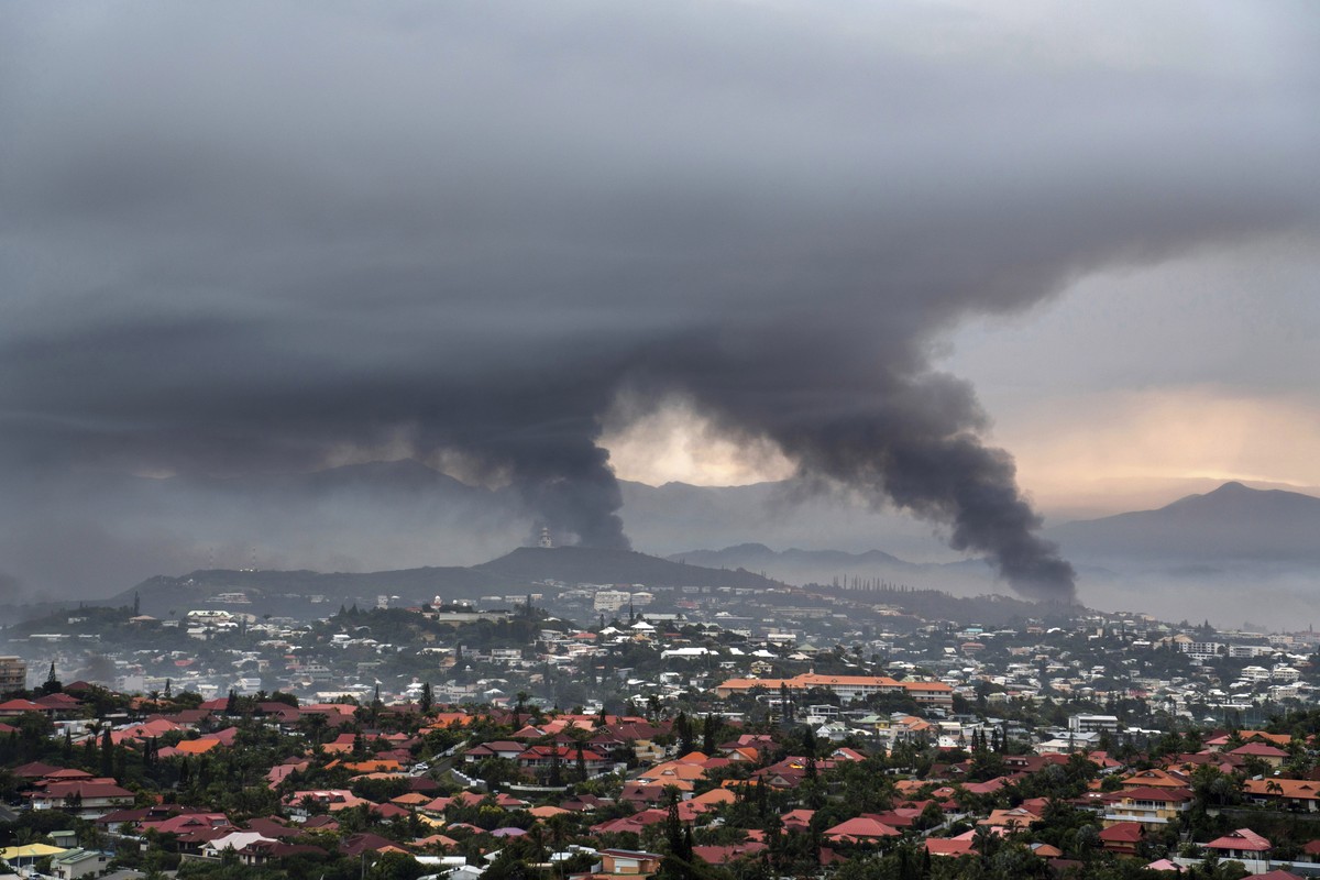 FILE - Smoke rises during protests in Noumea, New Caledonia, Wednesday May 15, 2024. France has imposed a state of emergency in the French Pacific territory of New Caledonia. The French prosecutor for ...