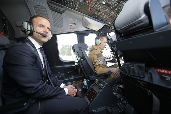 epa06036743 French President Emmanuel Macron is seated in the cockpit of an Airbus A400M turboprop transport plane before taking off from Villacoublay military airbase near Paris, France, 19 June 2017 ...