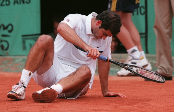 Top-seeded Pete Sampras of the USA is on the clay after he fell while trying to return a ball Ramon Delgado of Paraguay in the second round of the French Open tennis tournament in Paris Wednesday May  ...