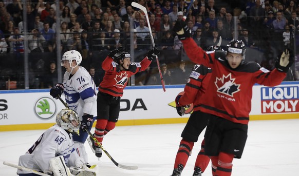 France&#039;s Florian Hardy, left, and France&#039;s Nicolas Besch, 2nd left, look as Canada&#039;s Jeff Skinner, center, and Canada&#039;s Brayden Schenn, right, celebrate their sides second goal dur ...