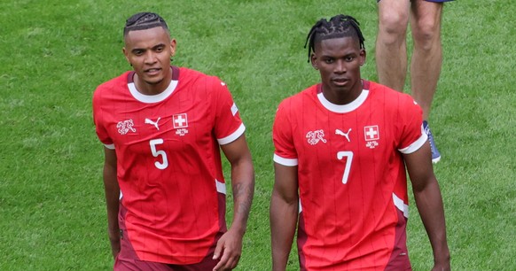 epa11412450 Manuel Akanji (L) and Breel Embolo (R) of Switzerland celebrate after winning the UEFA EURO 2024 group A match between Hungary and Switzerland in Cologne, Germany, 15 June 2024. EPA/OLIVIE ...