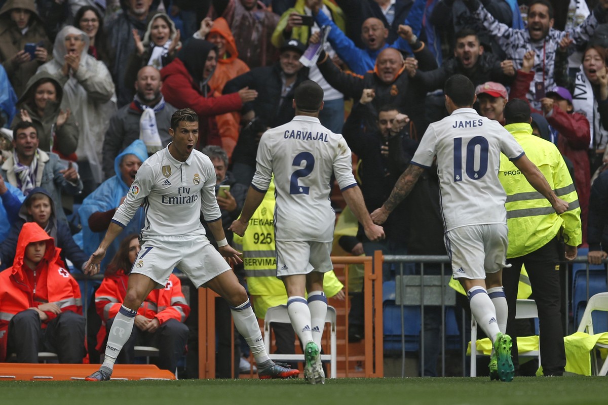 Real Madrid's Cristiano Ronaldo, left, celebrates after scoring the opening goal against Valencia during the Spanish La Liga soccer match between Real Madrid and Valencia at the Santiago Bernabeu ...