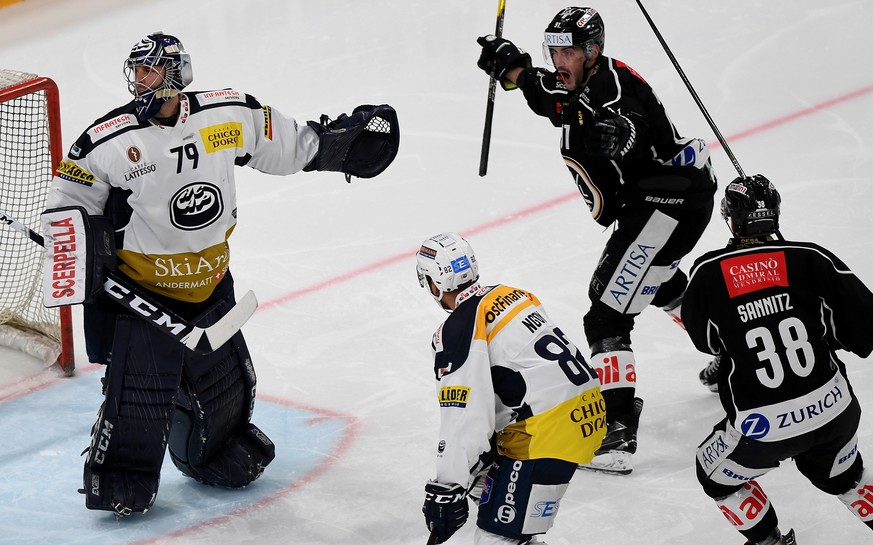 From left Ambri&#039;s goalkeeper Daniel Manzato, Lugano?s player Julian Walker, center, celebrates the 1 - 0 goal with Lugano?s player Raffaele Sannitz, right, during the preliminary round game of Na ...