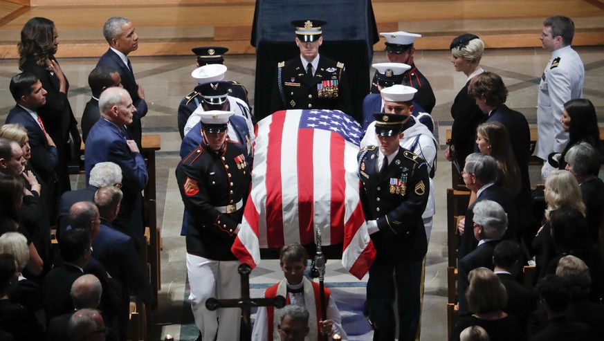 The family of Sen. John McCain, R-Ariz., follows as his casket is carried during the recessional at the end of a memorial service at Washington National Cathedral in Washington, Saturday, Sept. 1, 201 ...