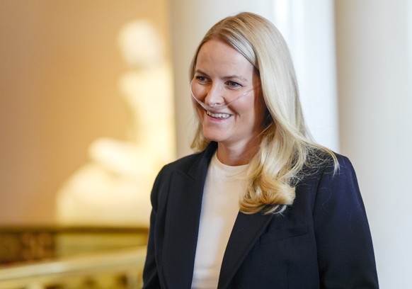 epa12880286 Norway's Crown Princess Mette Marit wears breathing assistance as the Crown Prince Family holds a reception for the Norwegian athletes from the Milano Cortina 2026 Winter Paralympic G ...