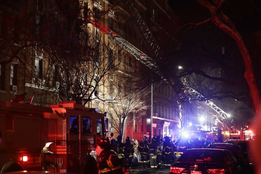 Firefighters respond to a building fire Thursday, Dec. 28, 2017, in the Bronx borough of New York. The Fire Department of New York says a blaze raging in the Bronx apartment building has seriously inj ...