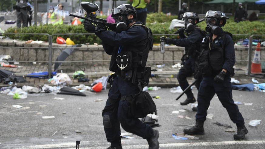 epa07643130 Police use rubber bullets on protesters during a rally against an extradition bill outside the Legislative Council in Hong Kong, China, 12 June 2019. The bill, scheduled for a second readi ...