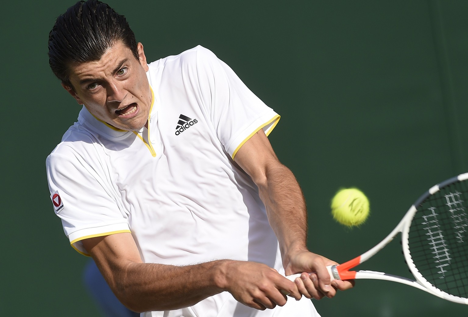 epa06066187 Sebastian Ofner of Austria returns to Thomaz Bellucci of Brazil in their first round match during the Wimbledon Championships at the All England Lawn Tennis Club, in London, Britain, 04 Ju ...