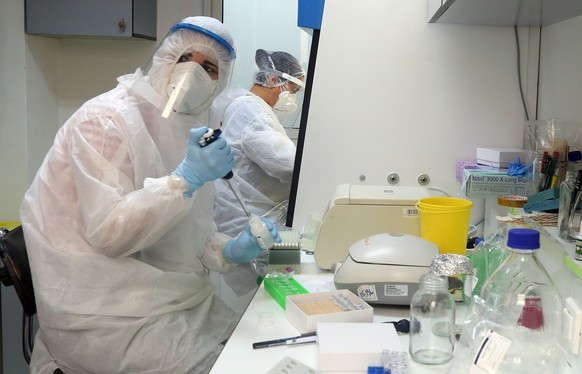 epa08369302 Staff of the Pasteur Institute in protective suits collect blood samples for serological tests at a drive-thru coronavirus testing laboratory in Tunis, Tunisia, 17 April 2020. Countries ar ...