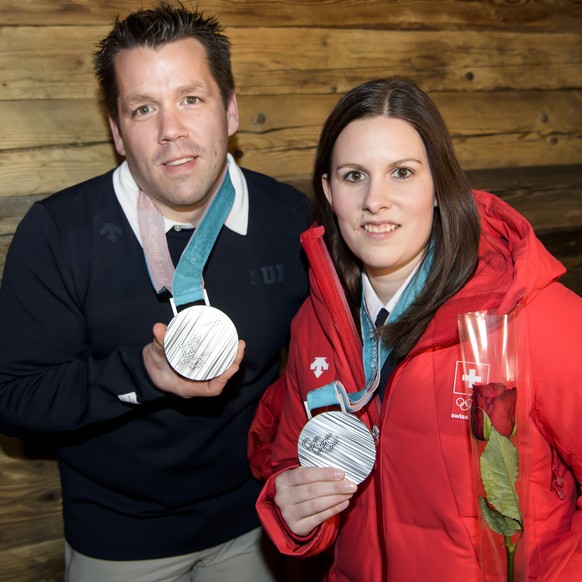 Martin Rios, left, and Jenny Perret, right, of Switzerland pose with their silver medals at the House of Switzerland after the victory ceremony of the curling mixed doubles at the XXIII Winter Olympic ...