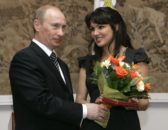 FILE - Russian President Vladimir Putin, left, congratulates Russian opera singer Anna Netrebko after awarding her with the People&#039;s Artist of Russia honor, during the 225th anniversary celebrati ...