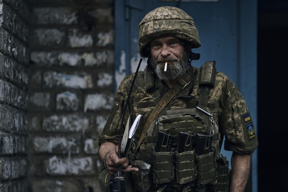 A Ukrainian soldier poses for a photograph on the frontline near Avdiivka, an eastern city where fierce battles against Russian forces have been taking place, in the Donetsk region, Ukraine, Friday, A ...