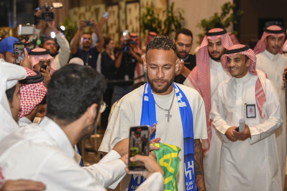 Brazilian national team's historical top scorer, and the star of Paris Saint-Germain, Neymar Jr. is surrounded by fans during his arrival at King Khalid International Airport in Riyadh, Saudi Ara ...