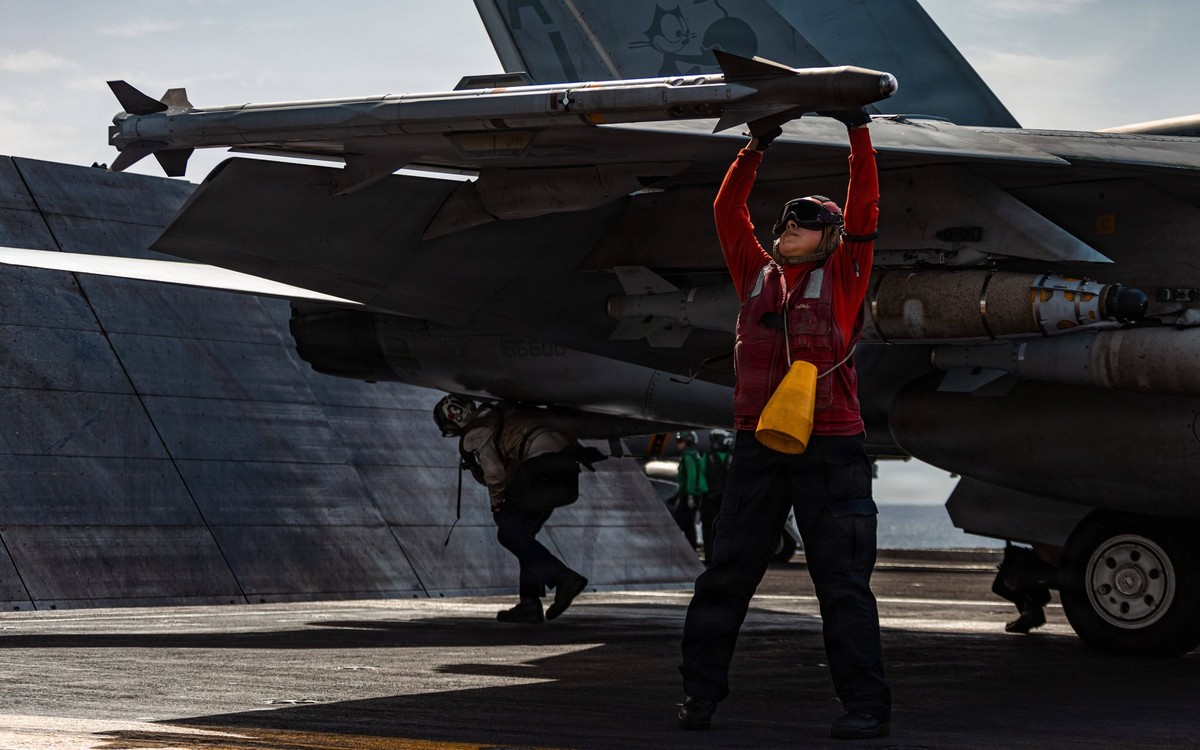 March 19, 2026, Undisclosed Location, International Waters: A U.S Navy ordnancemen checks the missiles of a F/A-18E Super Hornet fighter aircraft with the Tomcatters of Strike Fighter Squadron 31, bef ...