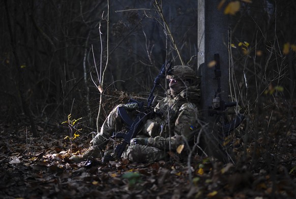 epa12518074 A handout photo made available by the press service of the 127th Separate Brigade of the Territorial Defence of Ukraine shows Ukrainian servicemen attending a military training near Kupian ...