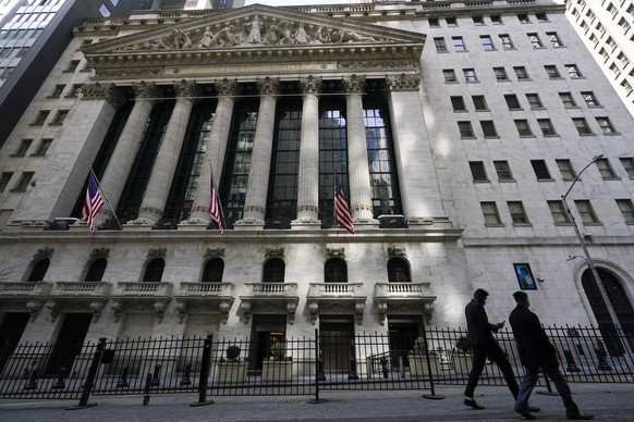 FILE - In this March 23, 2021 file photo, pedestrians walk past the New York Stock Exchange in New York&#039;s Financial District. Wall Street is gearing up for a blockbuster corporate earnings season ...