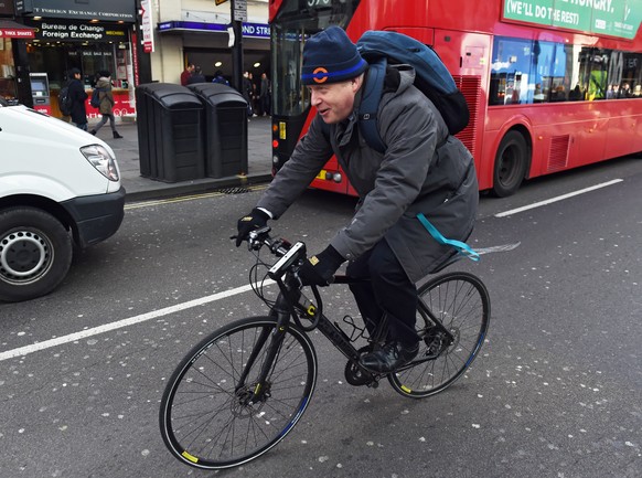 epa08932187 (FILE) - London Mayor Boris Johnson cycles along Oxford Street after attending an engagement with the Queen in the Cross Rail in Bond street in London, Britain, 23 February 2016 (Reissued  ...