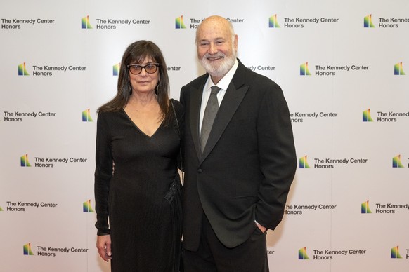 epa12593224 (FILE) - Rob Reiner (R) and Michelle Reiner (L) arrive for the Medallion Ceremony honoring the recipients of the 46th Annual Kennedy Center Honors at the Department of State in Washington, ...