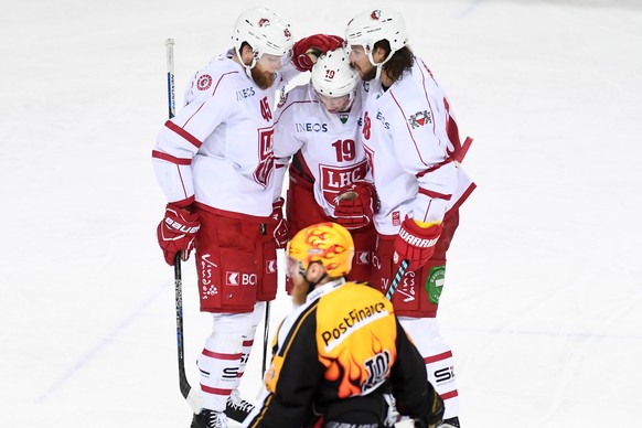 Lausanne&#039;s Jonas Junland, Gaetan Augsburger, and Sven Ryser, from left, celebrate the 3-2 goal, during the preliminary round game of National League A (NLA) Swiss Championship 2016/17 between HC  ...