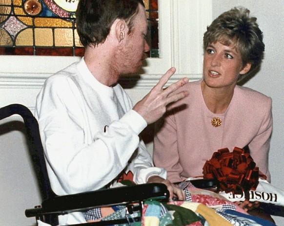FILE- In this file photo dated Oct. 26, 1991, Princess Diana talks with AIDS patient Wayne Taylor at the Casey House AIDS hospice in Toronto, Canada. For someone who began her life in the spotlight as