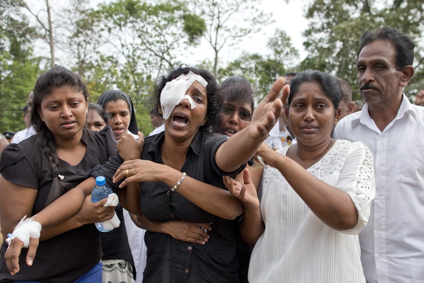 FILE- In this Wednesday, April 24, 2019 file photo, Anusha Kumari, center, weeps during a mass burial for her husband, two children and three siblings, all victims of Easter Sunday&#039;s bomb attacks ...