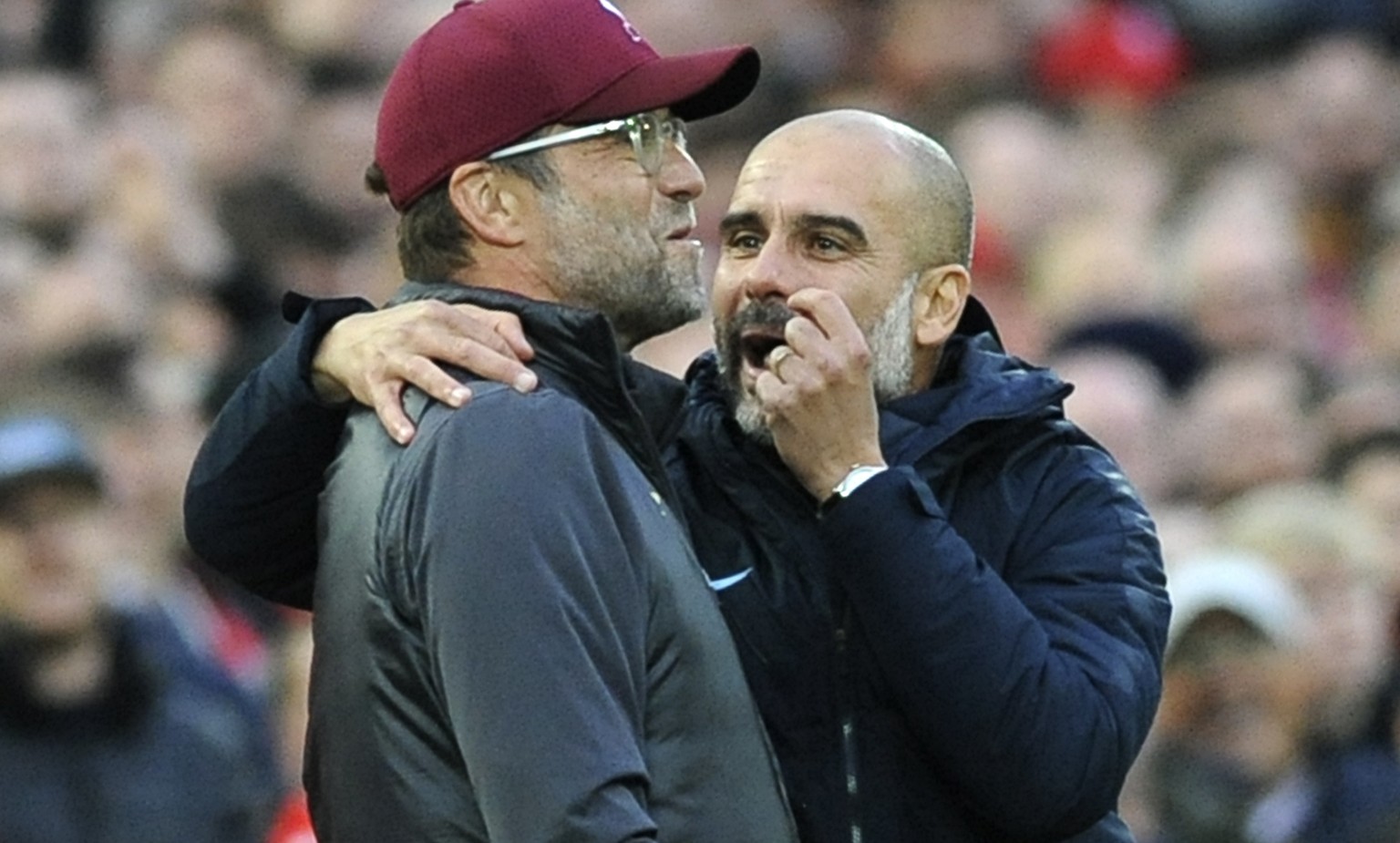 Manchester City manager Josep Guardiola, right, and Liverpool manager Juergen Klopp talk during the English Premier League soccer match between Liverpool and Manchester City at Anfield stadium in Live ...